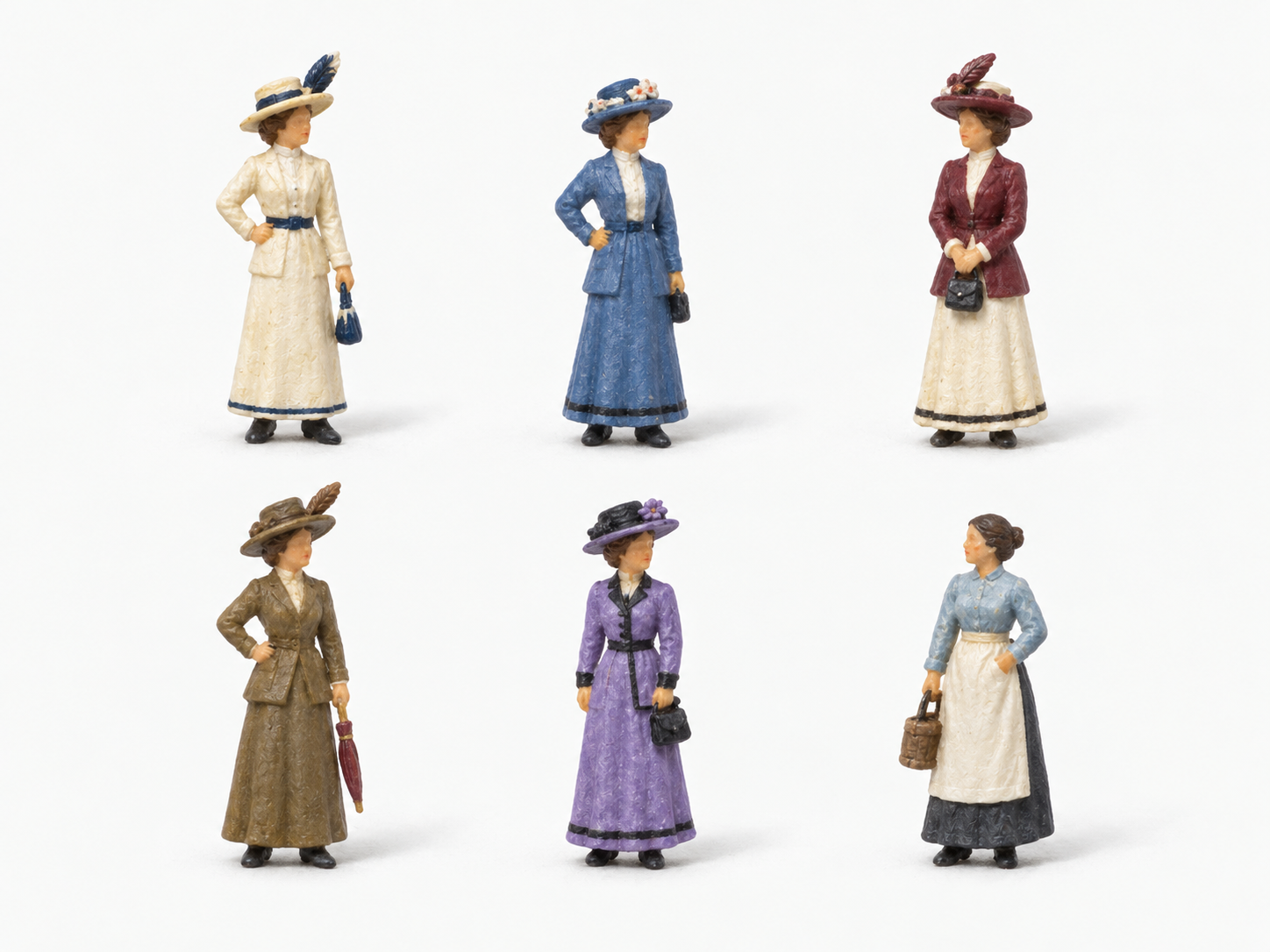 Sechs weibliche Modellfiguren in verschiedenen Kleidern und Kostümen um 1914